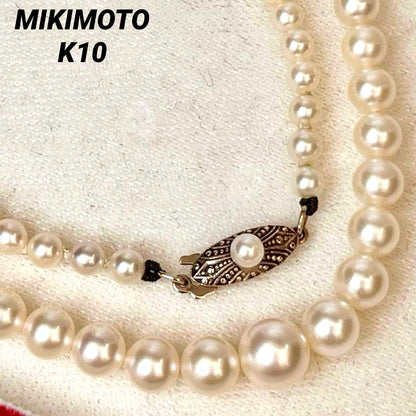 MIKIMOTO Gradient Necklace with cultured pearls ranging 3.6 to 7.0 mm and K10 metal clasp on a white background