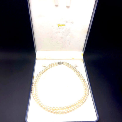 Takashi Akoya pearl two-strand necklace with silver clasp and 6-6.5 mm pearls on a white background