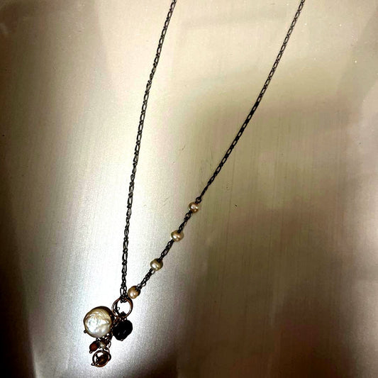 Agato silver pearl necklace with chain, beads, and charm on a white background