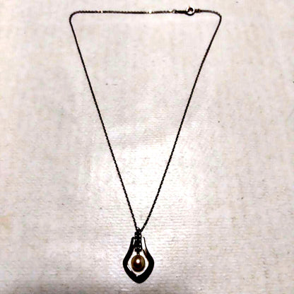 Mikimoto necklace featuring classic pearls in used condition with fine clasp and chain