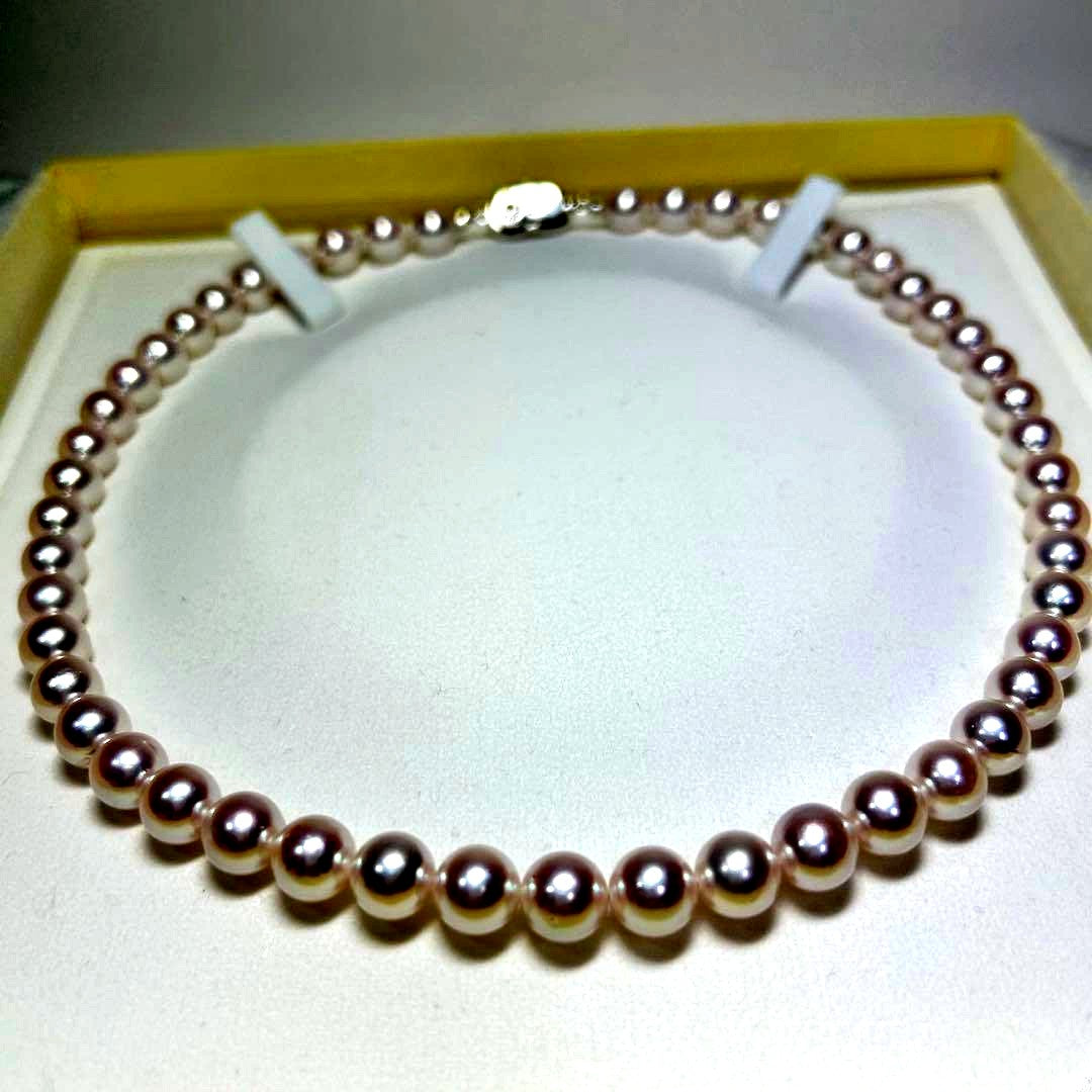 Akoya pearl necklace with 8-8.5 mm pearls and silver clasp on a white background