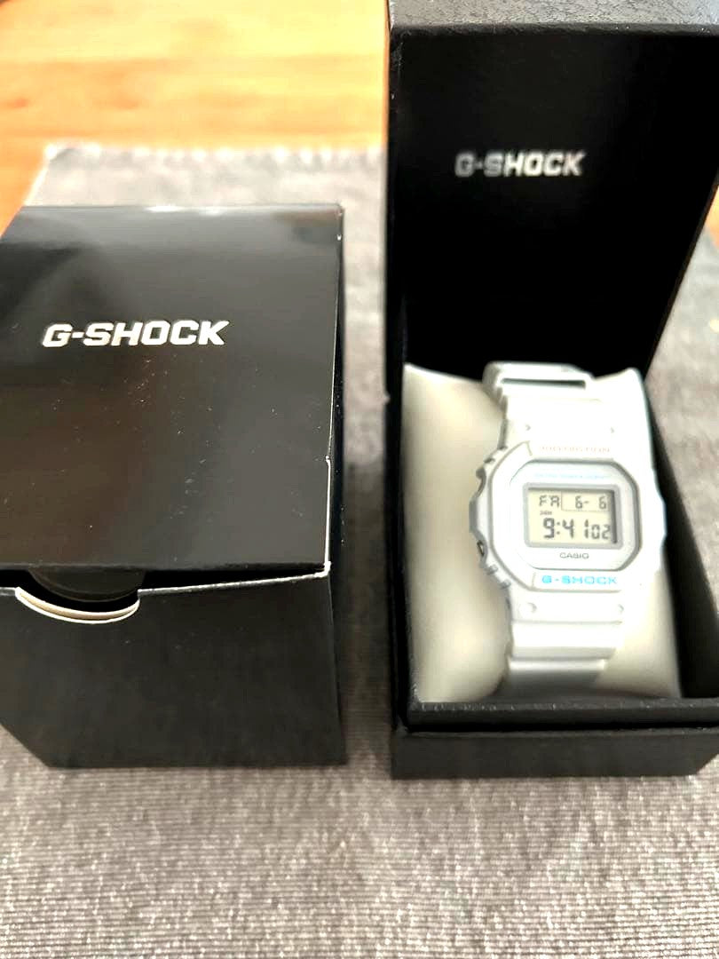 Casio G-Shock digital watch with white resin band and grayish white display, Japan import, shown with box