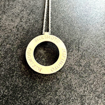 MIKIMOTO silver Circle Logo Necklace with 3 cm diameter pendant on a delicate chain