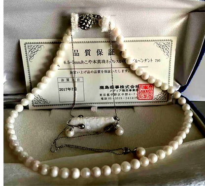 Akoya pearl necklace, earrings, and pendant set with 7mm pearls and silver clasp on white background