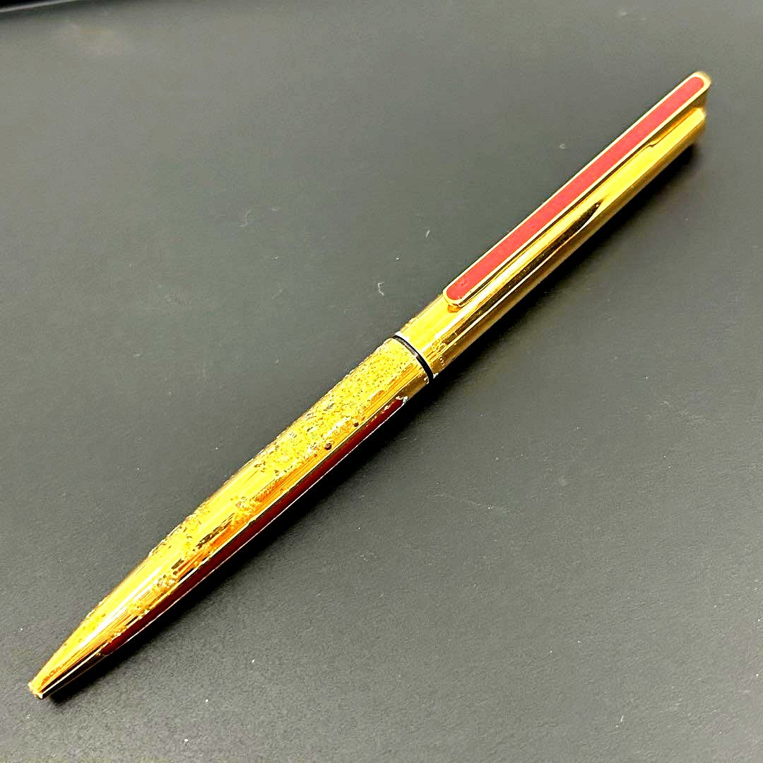 Vintage Waterman gold ballpoint pen in old condition with signs of wear and potential stains