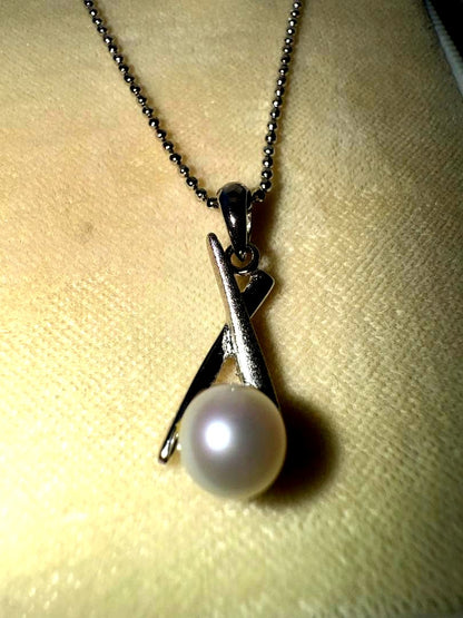 Tasaki silver necklace with a pearl pendant and lobster clasp displayed with a dedicated case