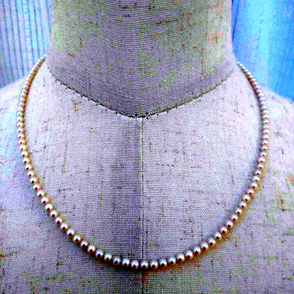 Close-up of Baby Akoya Pearl Necklace with 3-3.5mm pearls, 43cm length, displayed on a white background