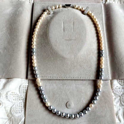 Akoya Pearl Semi-Long Necklace 87 featuring white and light gray pearls with silver clasp on a white background