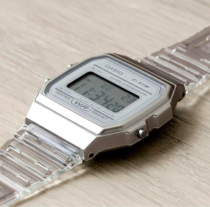 Casio digital watch with clear white skeleton case and resin band showing the LED display and buttons