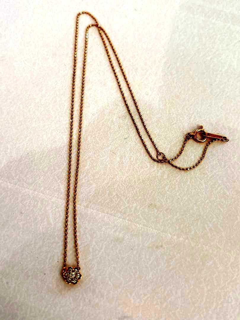 Agete flower motif necklace with 0.08ct diamond and adjustable 40.5 cm chain on white background