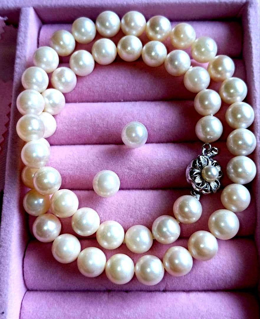 Akoya pearl necklace and matching earrings with 8.5mm round natural white pearls and silver clasp