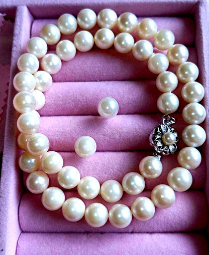 Akoya pearl necklace and matching earrings with 8.5mm round natural white pearls and silver clasp