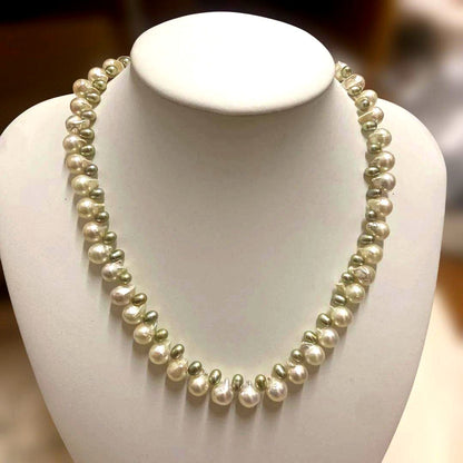 Akoya pearl and green freshwater pearl necklace measuring 45 cm length displayed on white background
