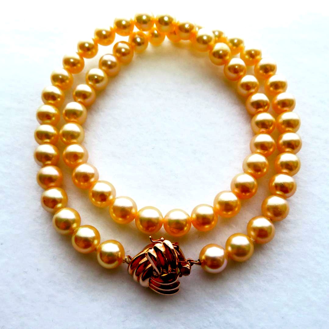 Akoya Pearl Necklace with K14 clasp, 44cm length, showcasing lustrous round pearls and certification tag