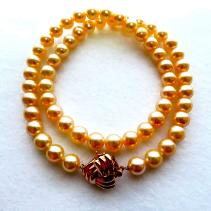 Akoya Pearl Necklace with K14 clasp, 44cm length, showcasing lustrous round pearls and certification tag