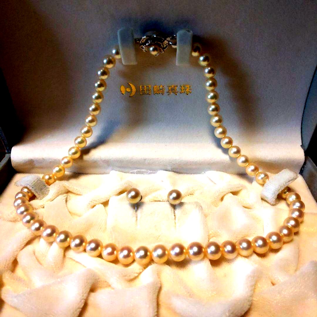Tasaki Akoya Pearl 7.0mm necklace and matching 7.0mm pearl earrings on a white background