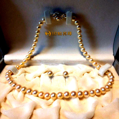Tasaki Akoya Pearl 7.0mm necklace and matching 7.0mm pearl earrings on a white background