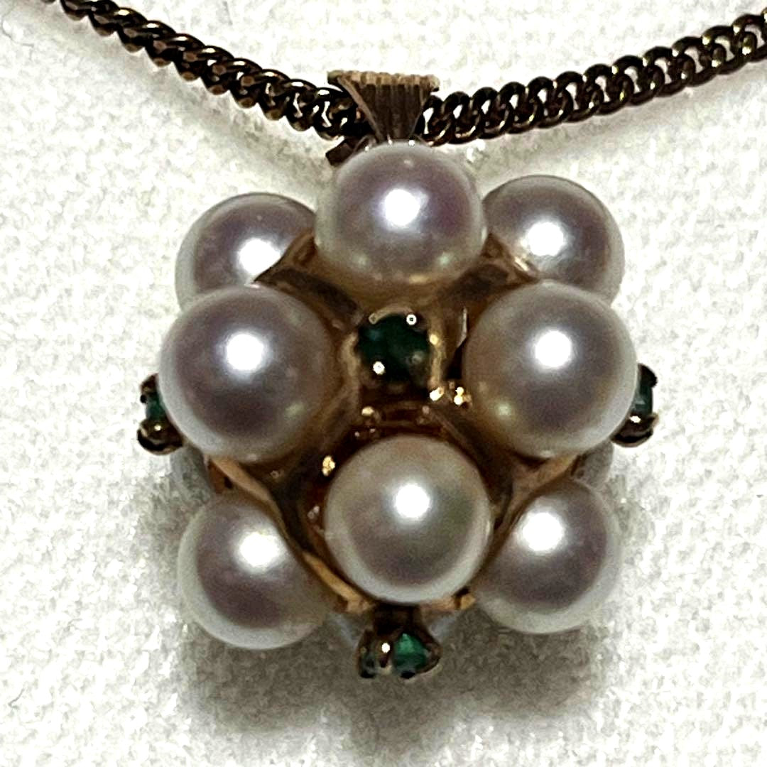 Akoya pearl necklace top with 12 round pearls and emerald-like green stones set in 14K gold weighing 3.7 grams