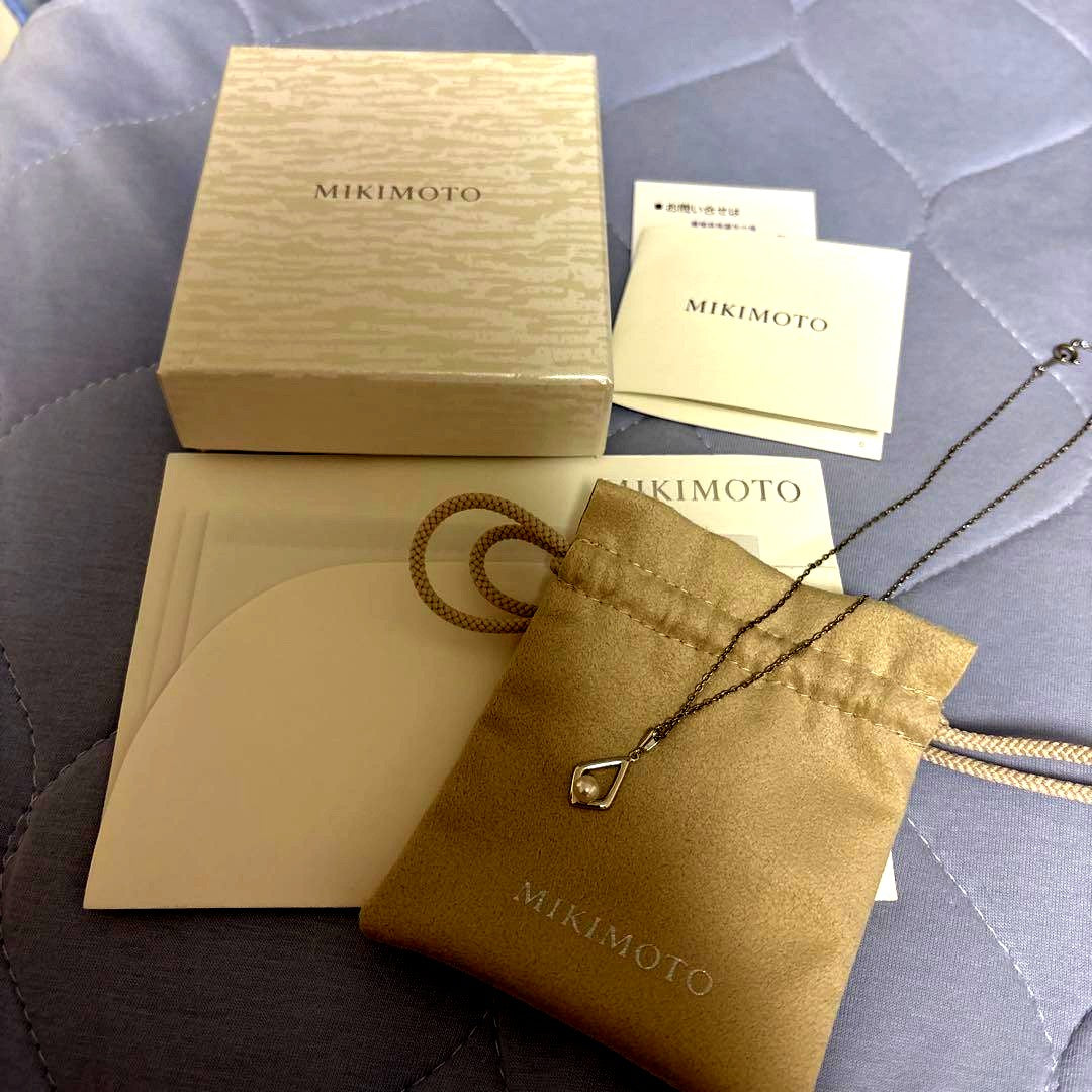 Mikimoto Pearl Necklace with silver chain and pearl pendant displayed with box and dedicated bag