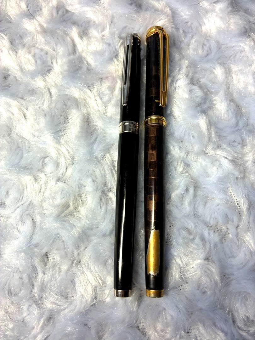 Set of 2 used Waterman fountain pens with gold accents shown side by side