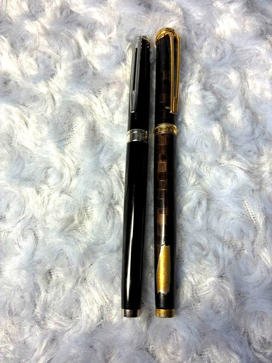 Set of 2 used Waterman fountain pens with gold accents shown side by side