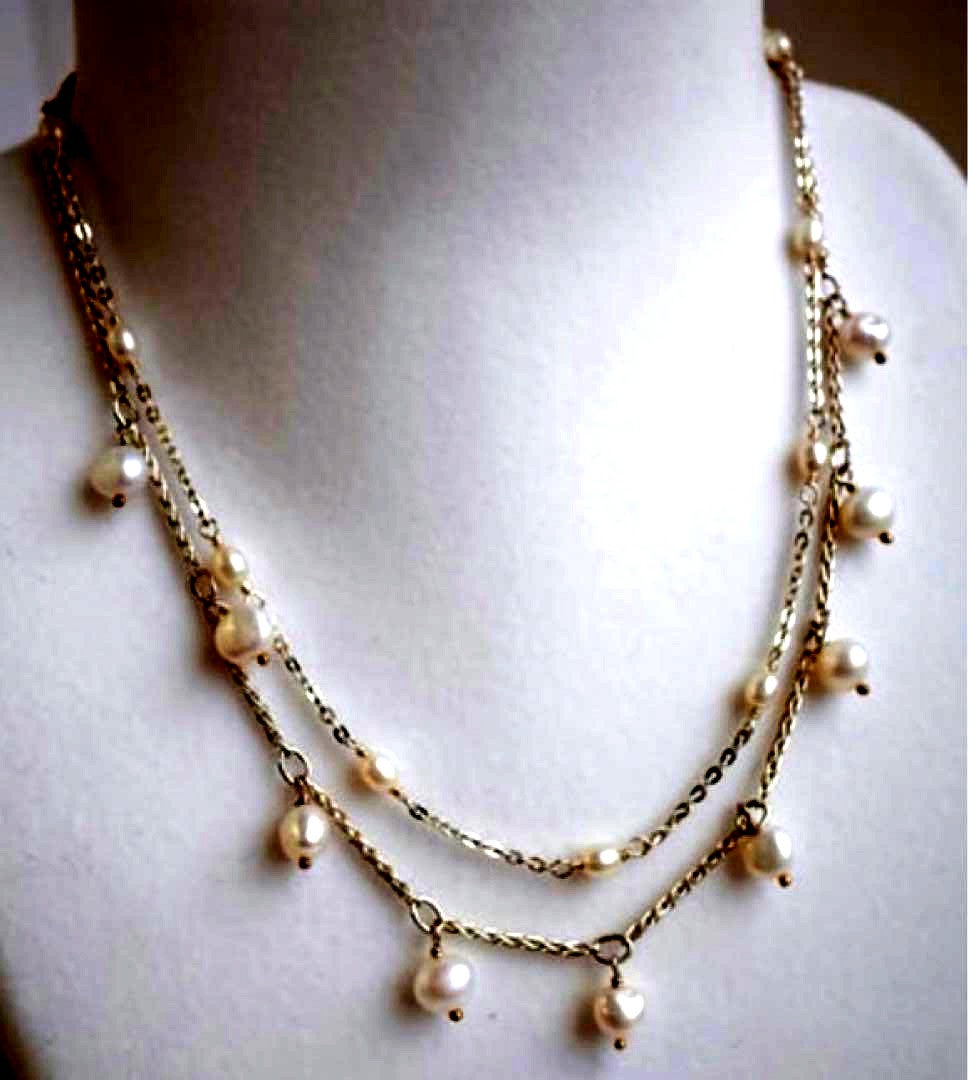 Akat necklace featuring two strands of varied size freshwater pearls on a 40 cm silver chain
