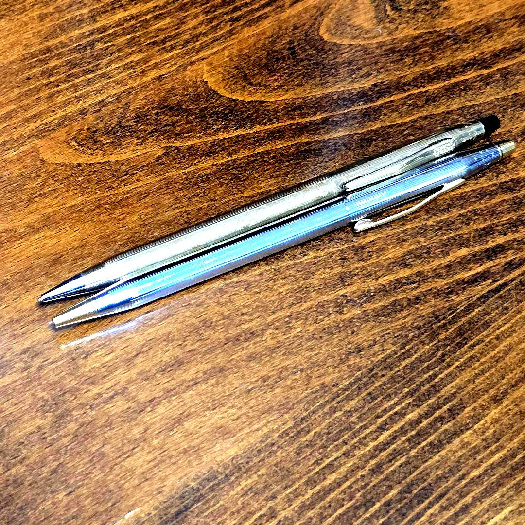 Cross Classic Century silver ballpoint pen and mechanical pencil set with engraved clips on a white background