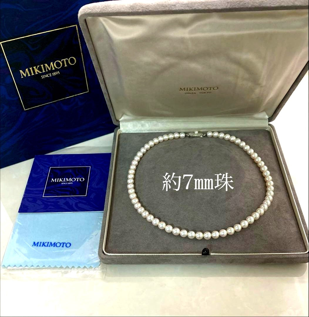 Mikimoto pearl necklace with approximately 7mm pearls and a silver clasp on a white background