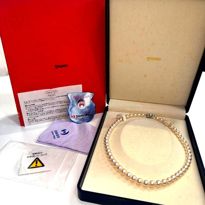Tasaki pearl necklace with ribbon clasp measuring 43.5 centimeters displayed on white background