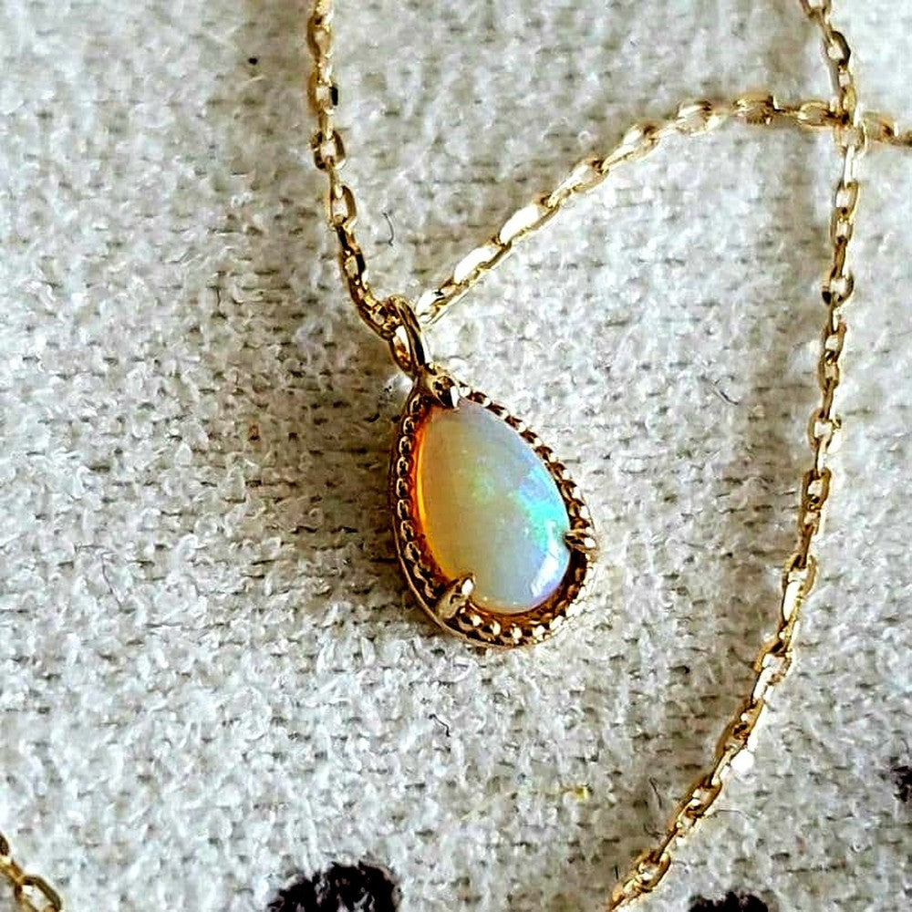 Opal droplet necklace with K10 gold and agate pendant on a delicate gold chain