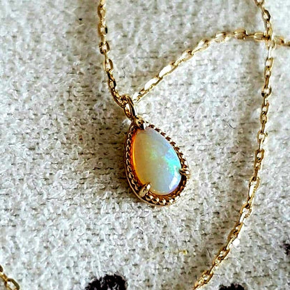 Opal droplet necklace with K10 gold and agate pendant on a delicate gold chain