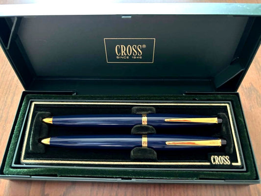 CROSS ballpoint pen and mechanical pencil set in navy and gold with a dedicated case showing slight cushion damage