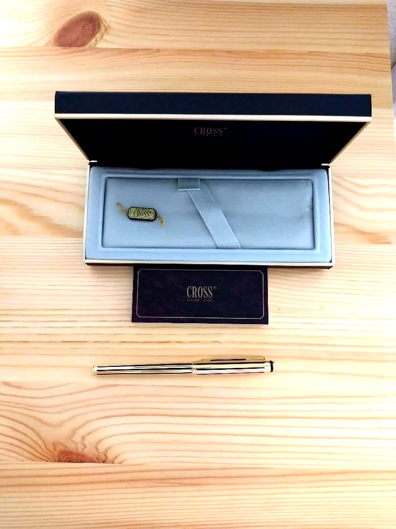 Used CROSS Selectip rolling ball pen in 22K gold with black lacquer finish and visible dent on pen body