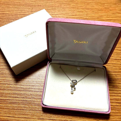 Tasaki freshwater pearl pendant set in silver displayed on a white background