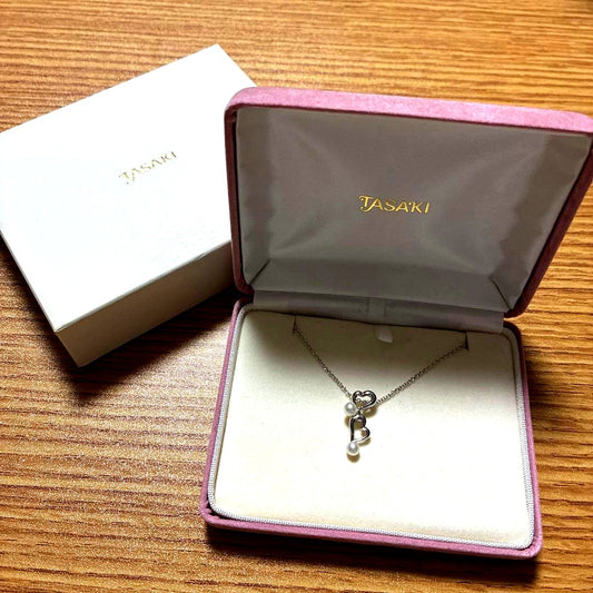 Tasaki freshwater pearl pendant set in silver displayed on a white background