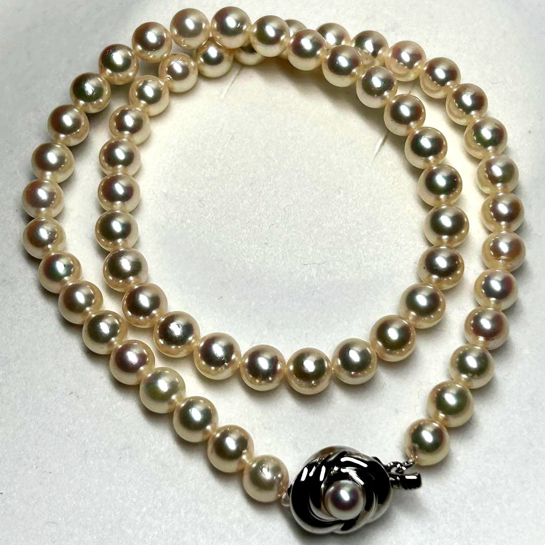 Tasaki Akoya pearl necklace with 7.5mm pearls and silver metal fittings laid flat
