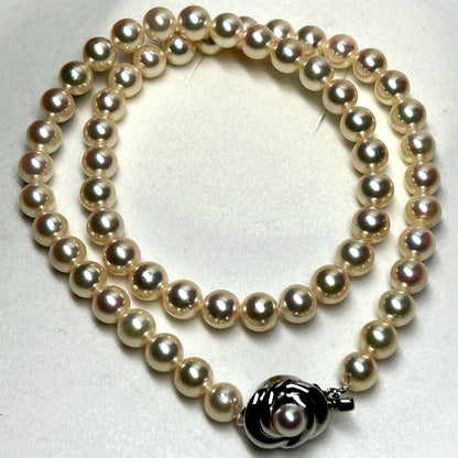 Tasaki Akoya pearl necklace with 7.5mm pearls and silver metal fittings laid flat