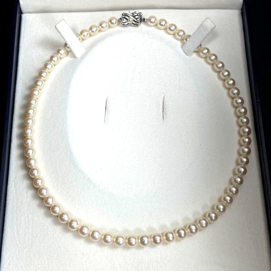 Tasaki Akoya pearl necklace with 6.5-7mm pearls and ribbon clasp displayed with jewelry box