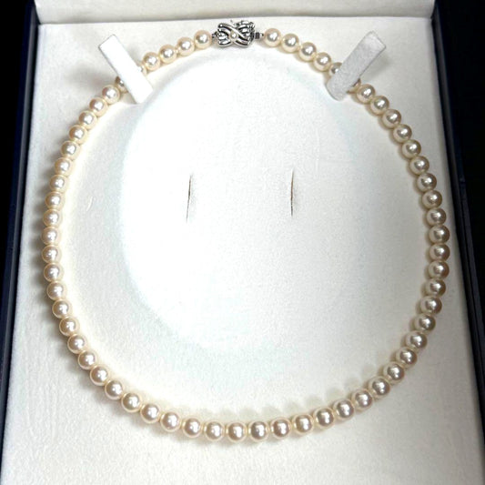 Tasaki Akoya pearl necklace with 6.5-7mm pearls and ribbon clasp displayed with jewelry box