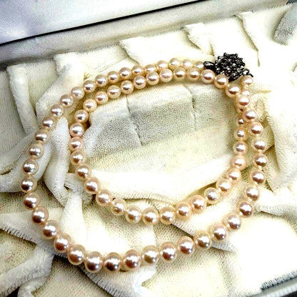 Yamato Akoya white pearl necklace with 5mm pearls and 41cm length displayed on a black background