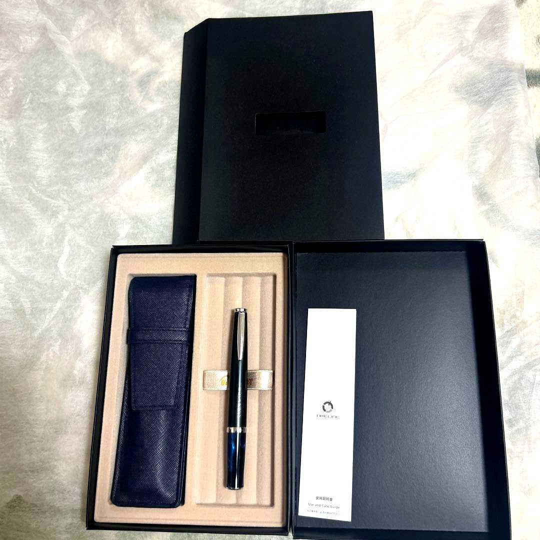 PILOT TIMELINE ballpoint pen with matte black body and blue marble grip alongside dedicated and pen cases