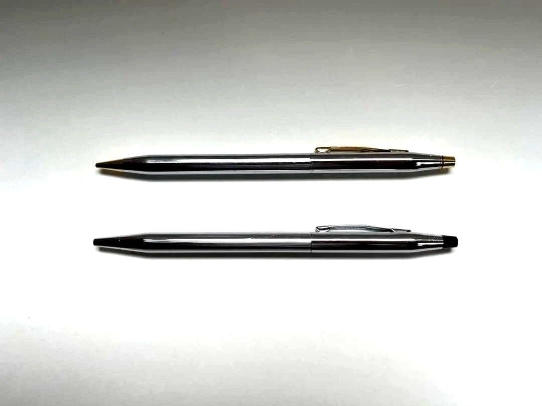 Cross ballpoint pen and mechanical pencil set shown without case, both in good condition with minor signs of use