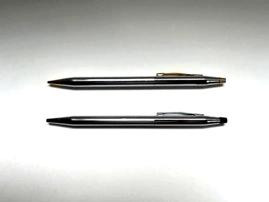 Cross ballpoint pen and mechanical pencil set shown without case, both in good condition with minor signs of use