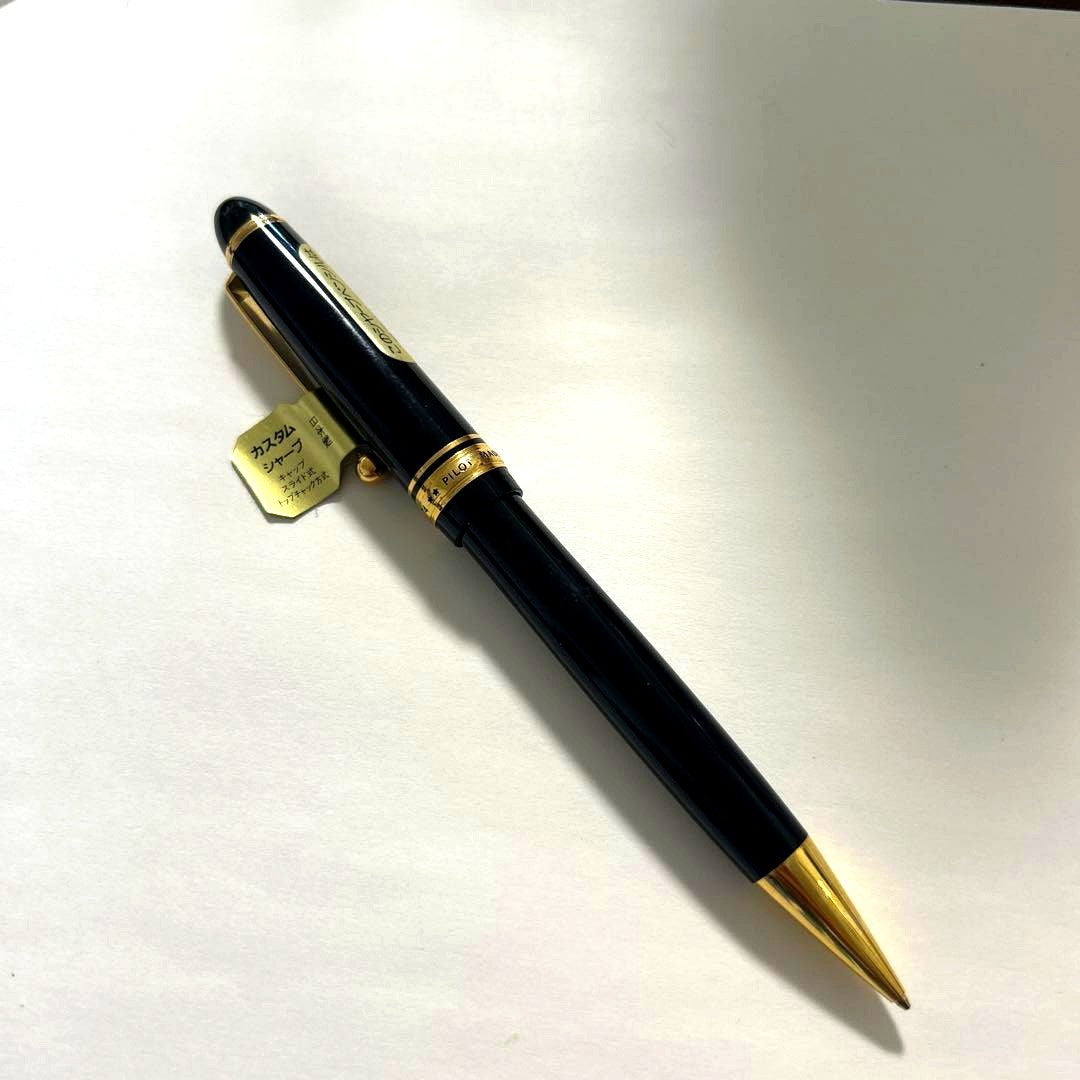 PILOT black ballpoint pen with gold accents and plastic body shown on white background