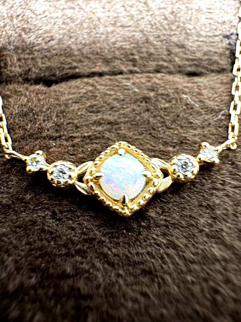 K10 Opal Necklace with opal and diamond accents set in K10 gold on a white background