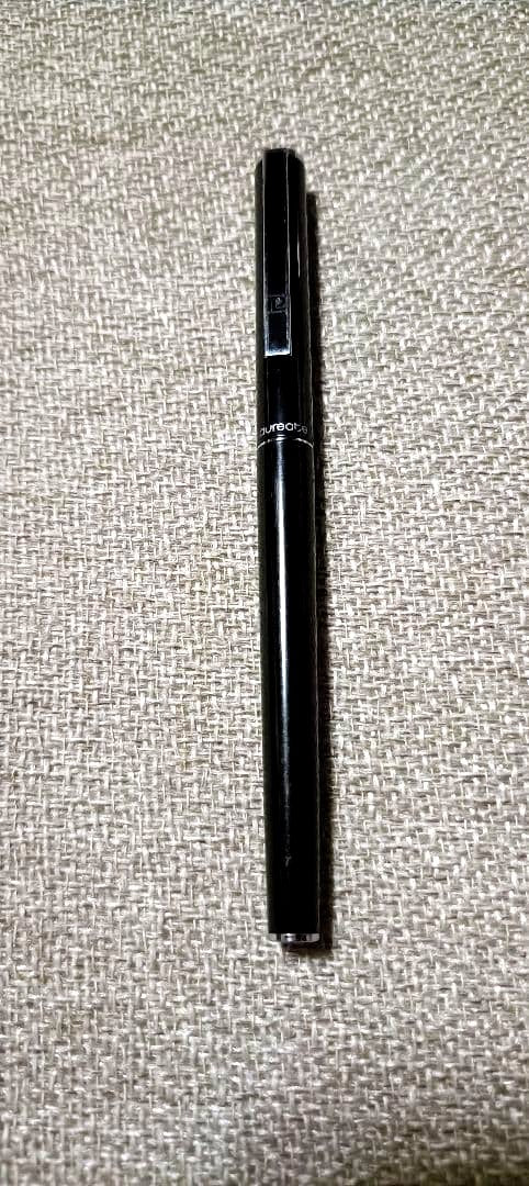 Pilot Laureate black and silver water-based ballpoint pen with cap on, showing light scratches and good condition
