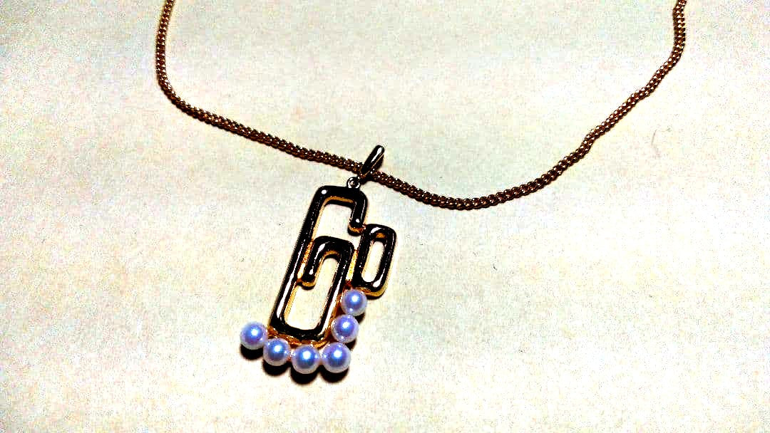 Mikimoto pearl necklace with gold and silver chain and 25mm by 15mm pearl pendant