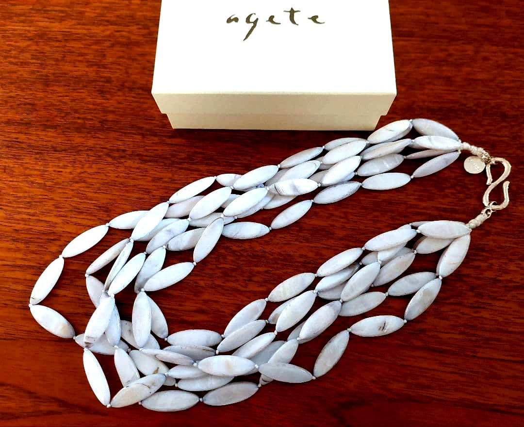Close-up of a new Agate Shell Necklace featuring natural shell beads and elegant design