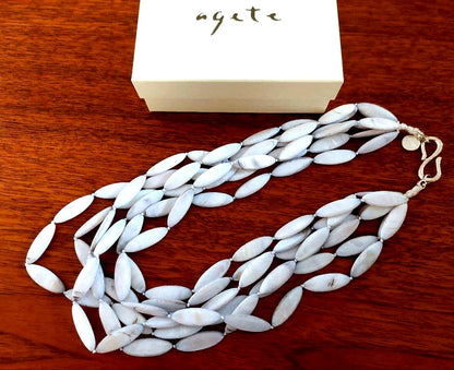 Close-up of a new Agate Shell Necklace featuring natural shell beads and elegant design