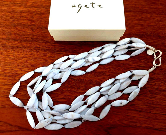 Close-up of a new Agate Shell Necklace featuring natural shell beads and elegant design